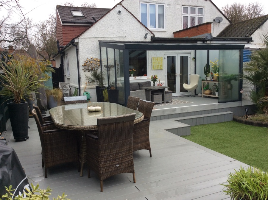 Garden with grey decking and sunroom
